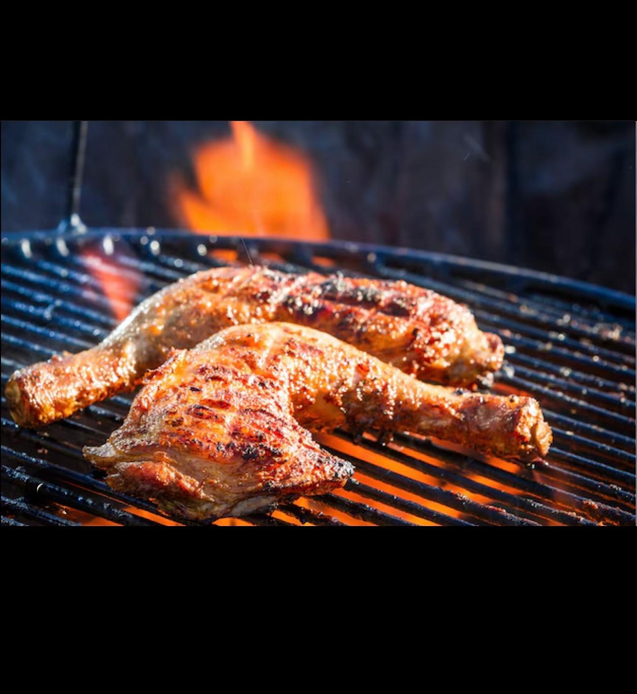 deliciously looking chicken thighs on a grill, with fire showing the cooking process. 