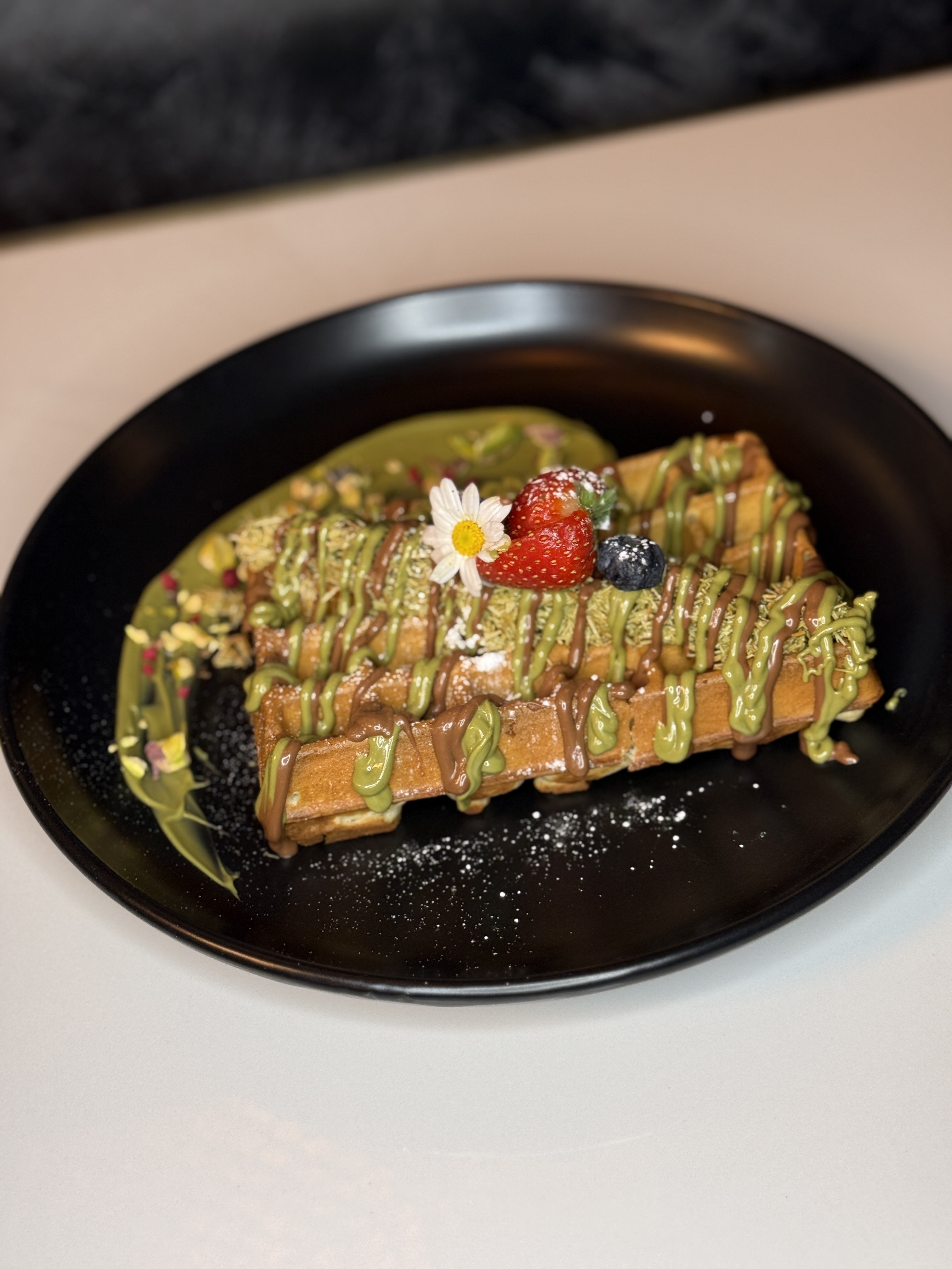 Best-selling pistachio waffle with chocolate drizzle and premium toppings