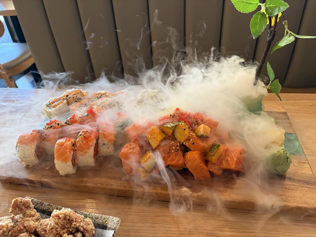 Specialty sushi rolls presented with a dramatic dry ice effect at Guildford Sushi House
