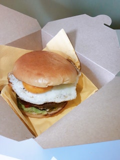 Veggie Rainbow Bun - Large flat mushroom; tomato; fried egg; avocado smash; caramelised onions; chutney and; a brioche bun.